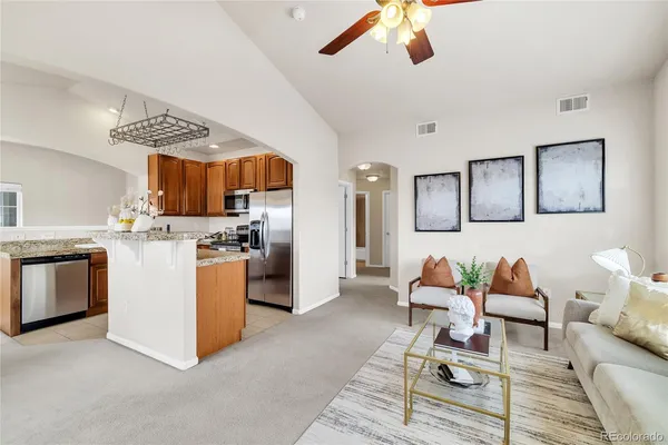 a living room with furniture and kitchen view