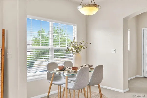 a view of a dining room with furniture and a window