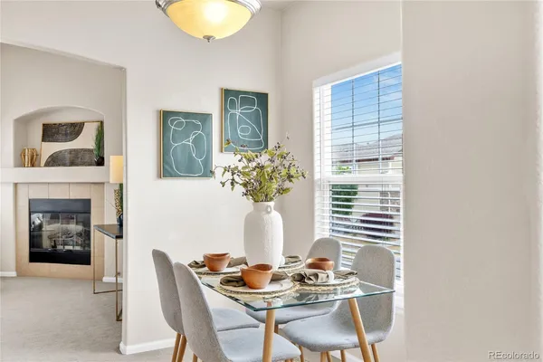 a dining room with furniture and fireplace