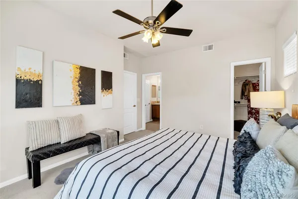 a bedroom with bed and a chandelier