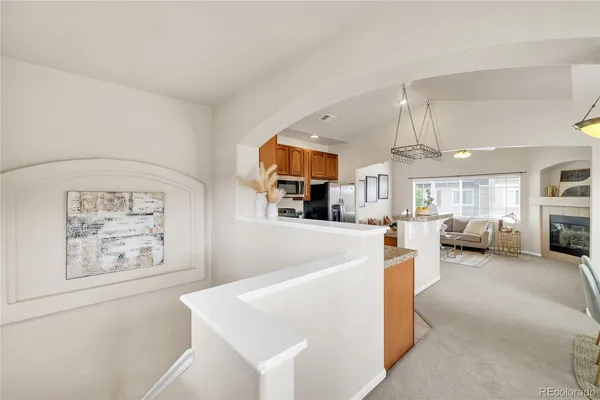 a living room with furniture and kitchen view