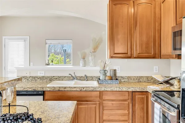 a kitchen with granite countertop a sink and a stove