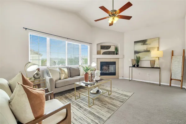 a living room with furniture and a fireplace