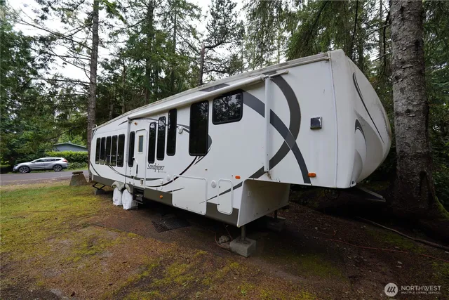 a view of a house with a yard and sitting area