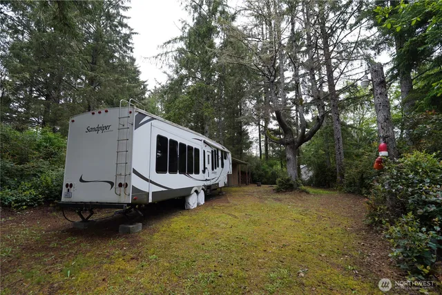 a view of a house with a yard deck and a garden