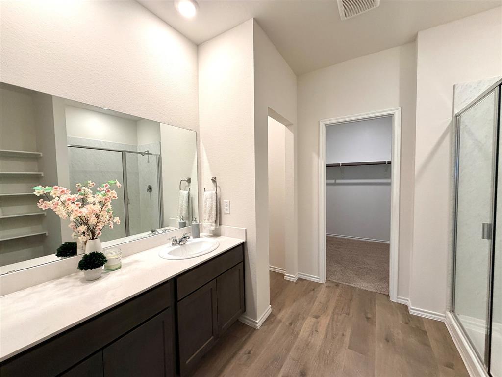 816 Country Road Royse City, TX 75189 - Photo 7 of 24 Full vanity with a single basin, light-toned countertop, and dark wood-finish cabinetry