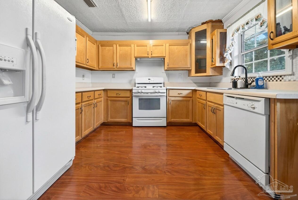 6253 Allentown Road Milton, FL 32570 - Photo 2 of 31 a kitchen with stainless steel appliances granite countertop a stove a sink and a refrigerator