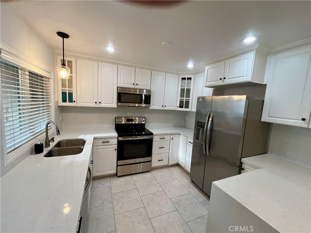 34134 Selva Road, Unit 248 Dana Point, CA 92629 - Photo 13 of 41 a kitchen with stainless steel appliances a refrigerator sink and microwave