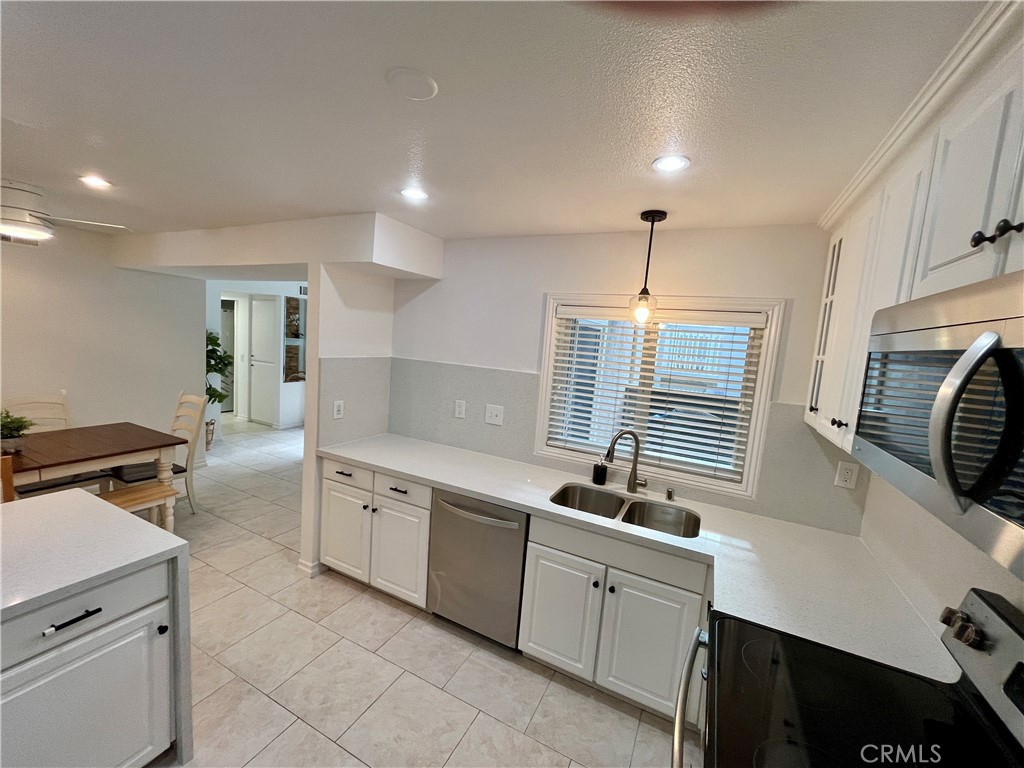 34134 Selva Road, Unit 248 Dana Point, CA 92629 - Photo 14 of 41 a kitchen with granite countertop a sink stove and cabinets
