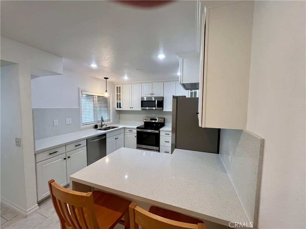 34134 Selva Road, Unit 248 Dana Point, CA 92629 - Photo 17 of 41 a kitchen with stainless steel appliances a refrigerator sink and stove