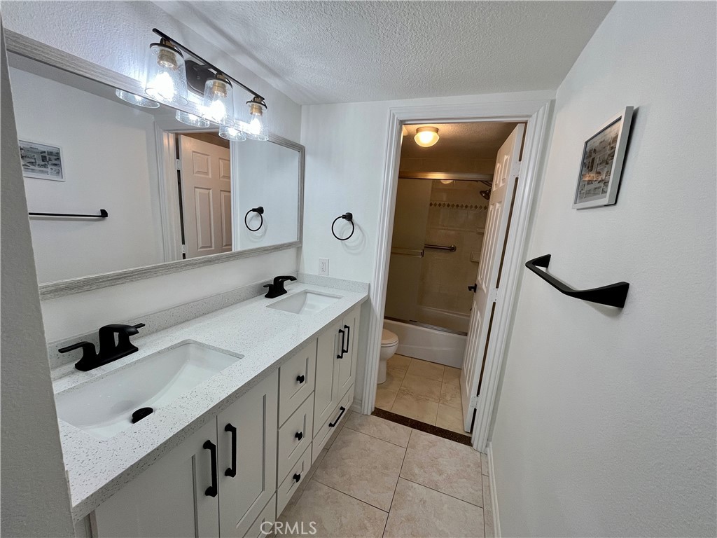 34134 Selva Road, Unit 248 Dana Point, CA 92629 - Photo 24 of 41 a bathroom with a double vanity sink and mirror