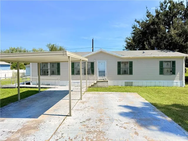 a view of a house with a yard patio and swimming pool