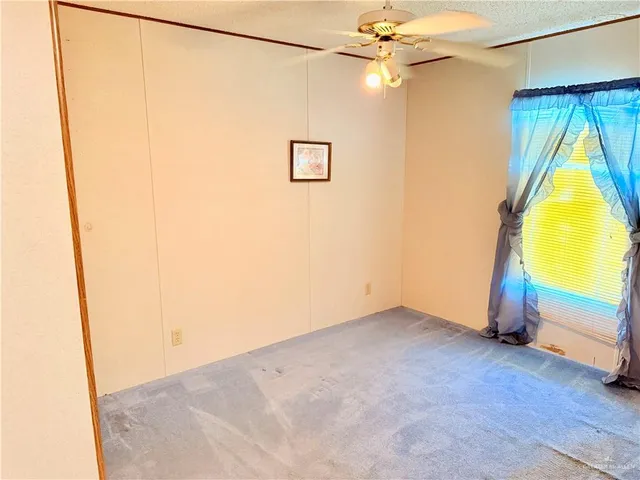 a view of a room with wooden floor and a window