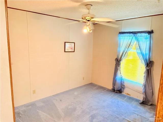 a bathroom with a toilet and a shower curtain