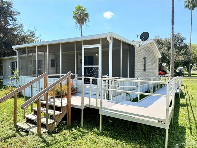 a view of a chair and tables in the balcony
