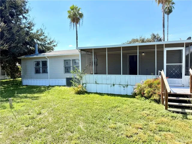 a house view with a sitting space and garden