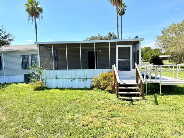 a view of a house with backyard porch and sitting area