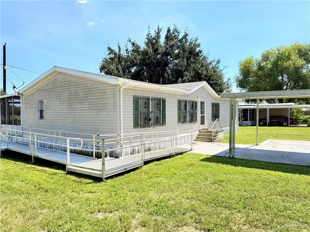 a view of a house with a backyard
