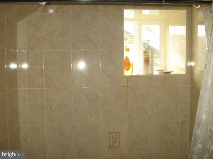 7007 Hilltop Road Upper Darby, PA 19082 - Photo 14 of 20 a bathroom with a window and a shower