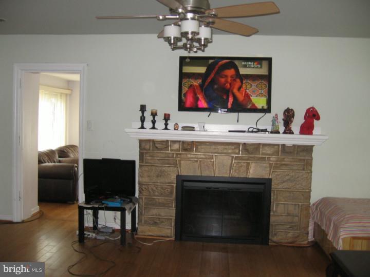 7007 Hilltop Road Upper Darby, PA 19082 - Photo 5 of 20 a living room with furniture a fireplace and flat screen tv