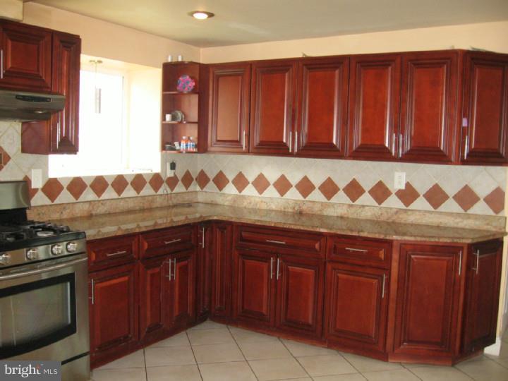 7007 Hilltop Road Upper Darby, PA 19082 - Photo 6 of 20 a kitchen with a sink dishwasher stove and cabinets