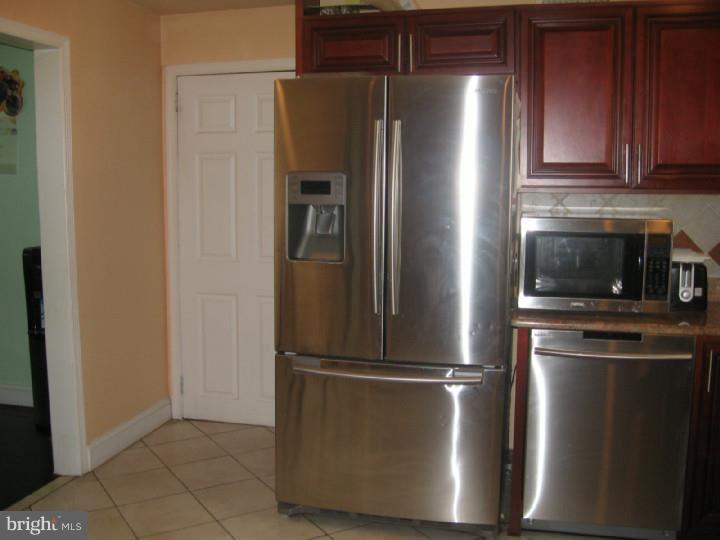 7007 Hilltop Road Upper Darby, PA 19082 - Photo 8 of 20 a metallic refrigerator freezer sitting in a kitchen