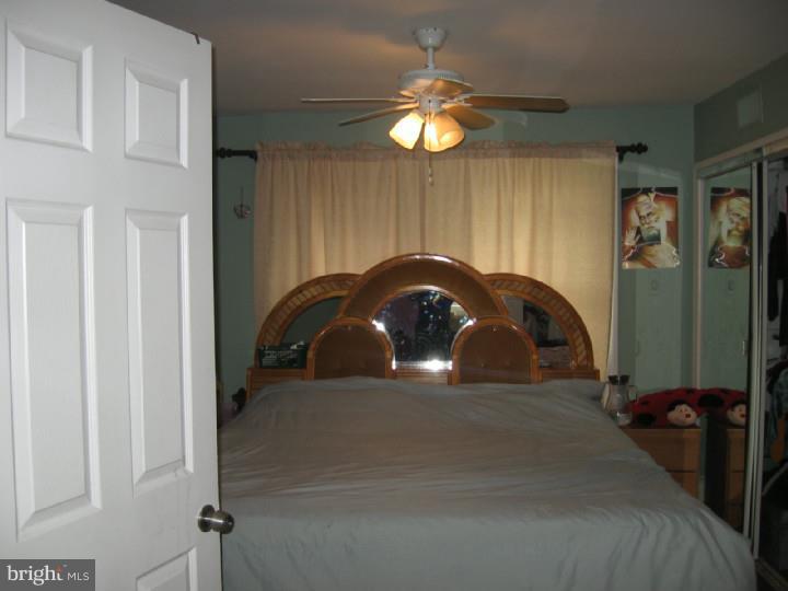 7007 Hilltop Road Upper Darby, PA 19082 - Photo 10 of 20 a bedroom with a bed and a chandelier