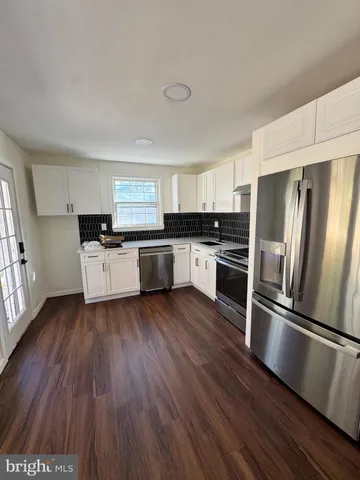 a view of an empty room and wooden floor