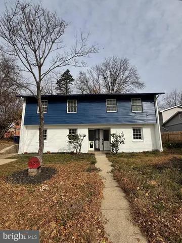a view of a house with a yard covered with snow
