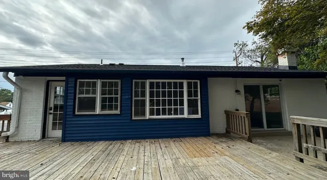 a view of a kitchen with wooden floor and electronic appliances