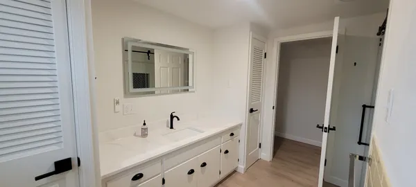 a bathroom with a double vanity sink and mirror