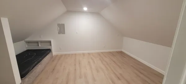 a view of an empty room and wooden floor