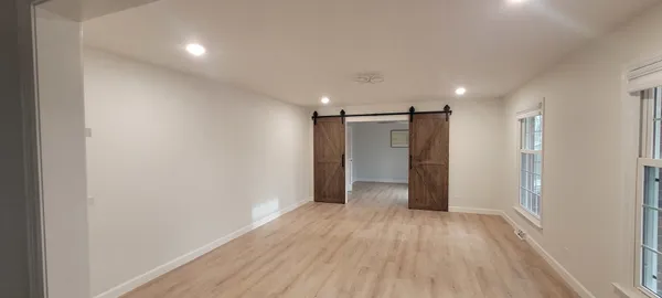 a view of hallway with wooden floor