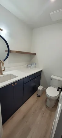 a bathroom with a toilet sink and mirror