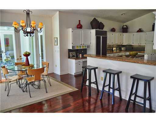 3205 Northwest 59th Street Boca Raton, FL 33496 - Photo 8 of 23 a view of a dining room with furniture and a chandelier
