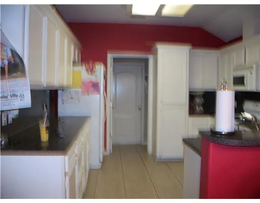 a kitchen with stainless steel appliances granite countertop a sink refrigerator and microwave