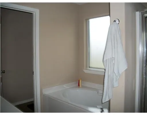a bathroom with a sink vanity and tub