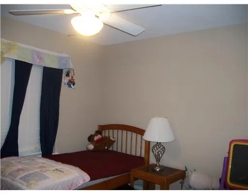 a bedroom with a bed and a mirror