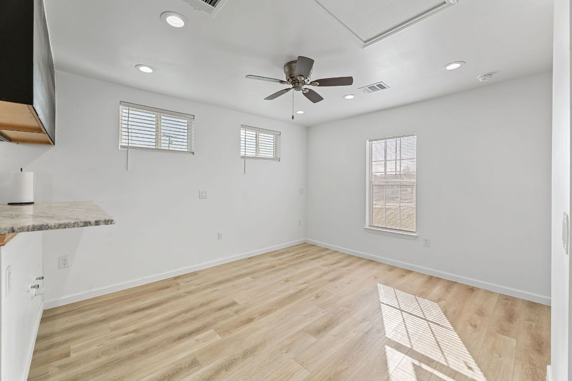 603 East 3rd Street Taylor, TX 76574 - Photo 13 of 30 a view of empty room with wooden floor and fan