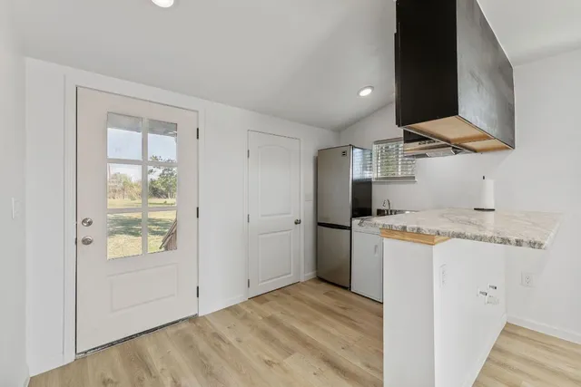 a kitchen with a refrigerator a stove and a microwave oven