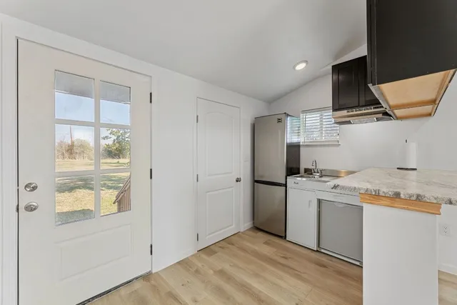 a kitchen with stainless steel appliances granite countertop a stove and a refrigerator