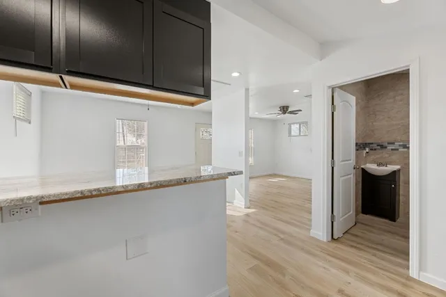 a view of a kitchen with a sink and cabinets