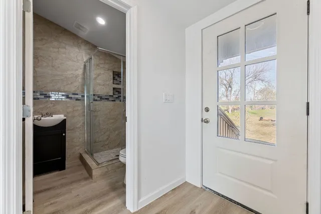 a bathroom with a glass shower door
