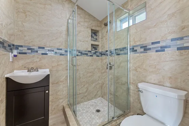 a bathroom with a sink toilet and shower