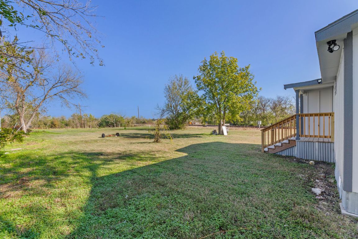 603 East 3rd Street Taylor, TX 76574 - Photo 25 of 30 a view of yard with swimming pool and trees
