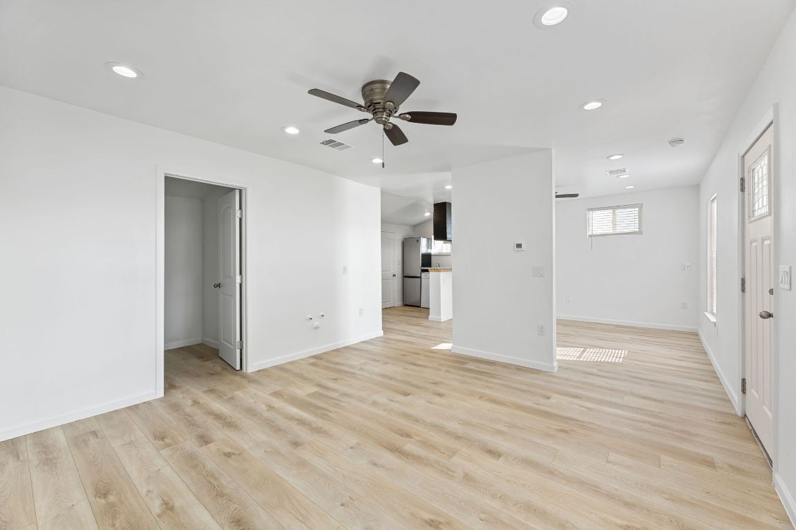 603 East 3rd Street Taylor, TX 76574 - Photo 9 of 30 a view of empty room with wooden floor and ceiling fan
