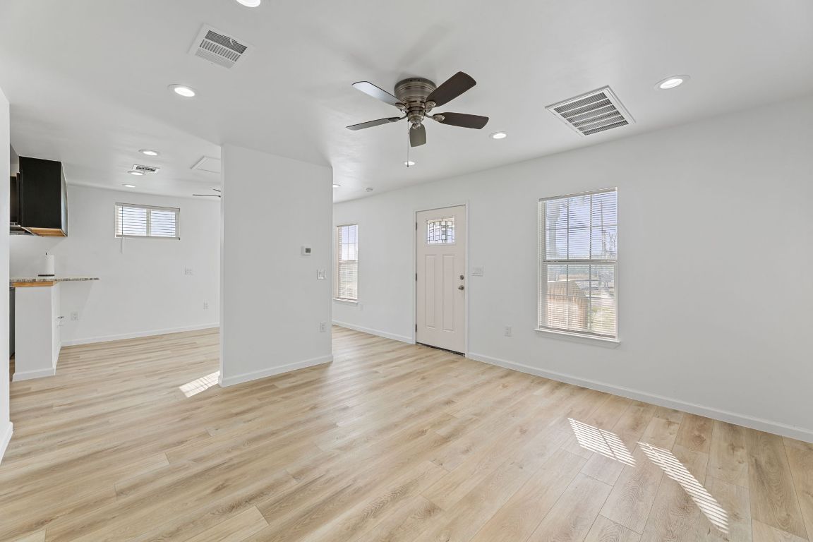 603 East 3rd Street Taylor, TX 76574 - Photo 10 of 30 a view of an empty room with a window and wooden floor
