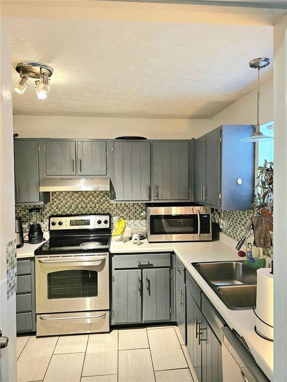 6433 Stone Way Morrow, GA 30260 - Photo 3 of 8 a kitchen with a stove sink and refrigerator