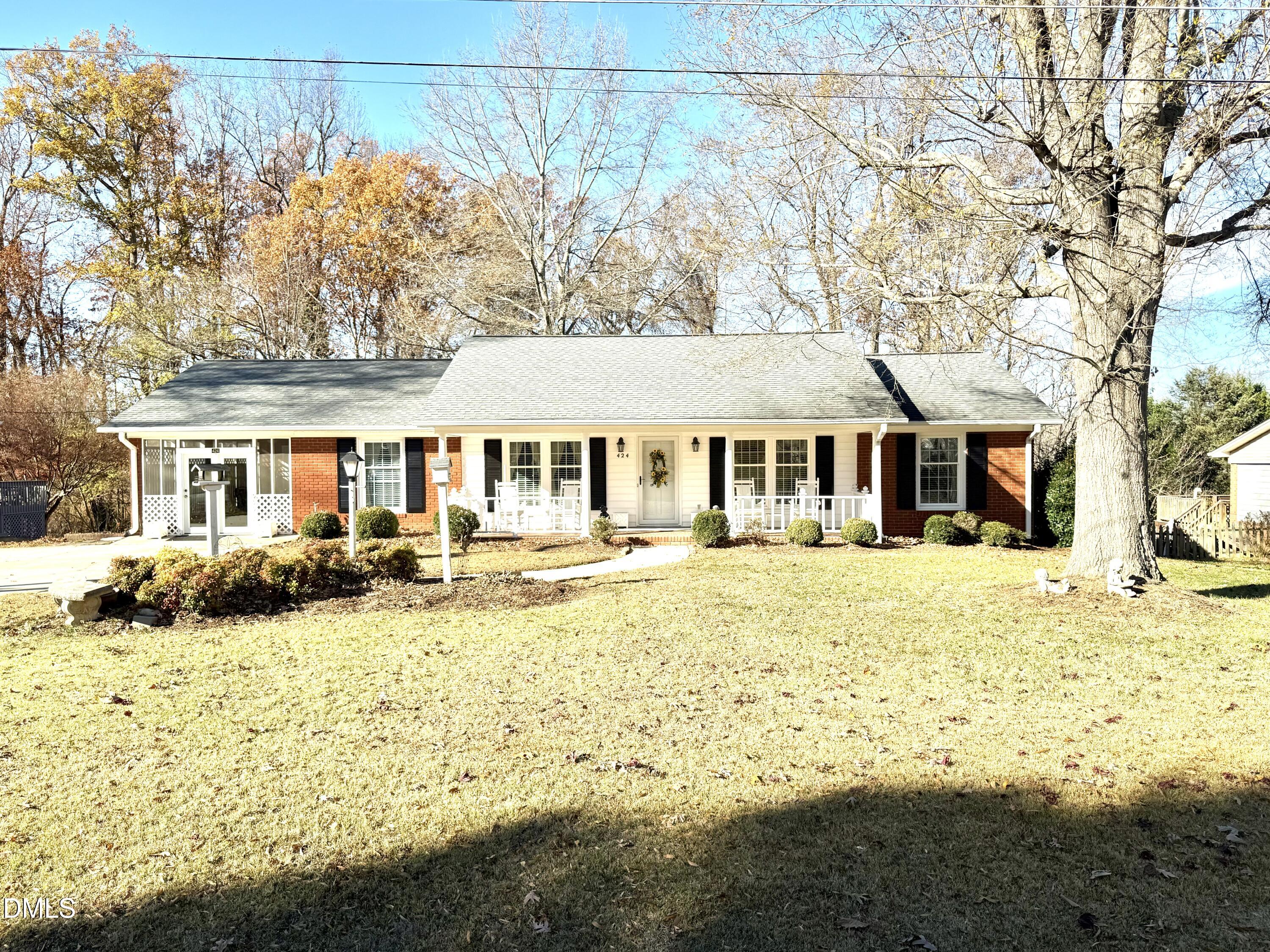 a front view of a house with swimming pool and sitting area
