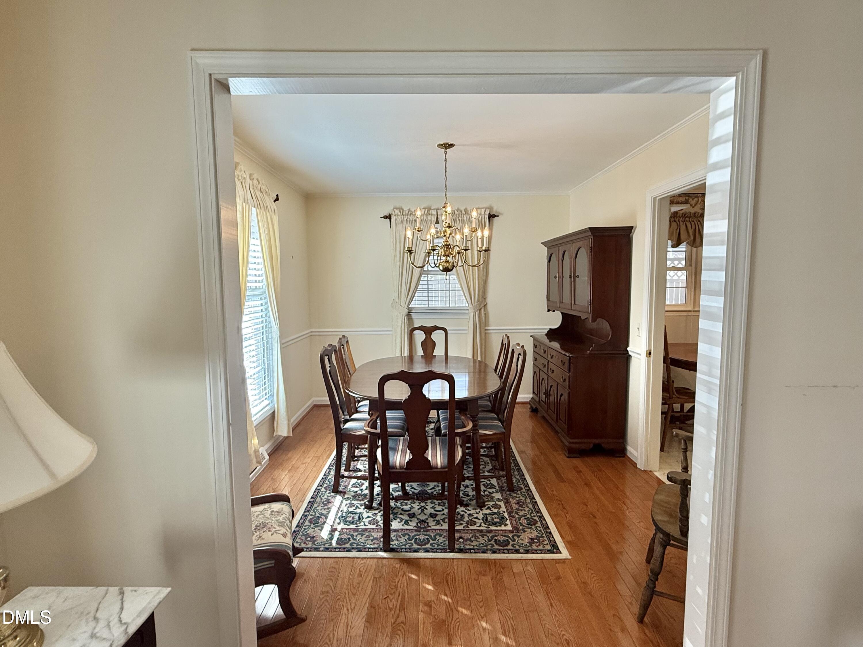 424 Tanglewood Circle Roxboro, NC 27573 - Photo 11 of 47 a view of a dining room with furniture and chandelier